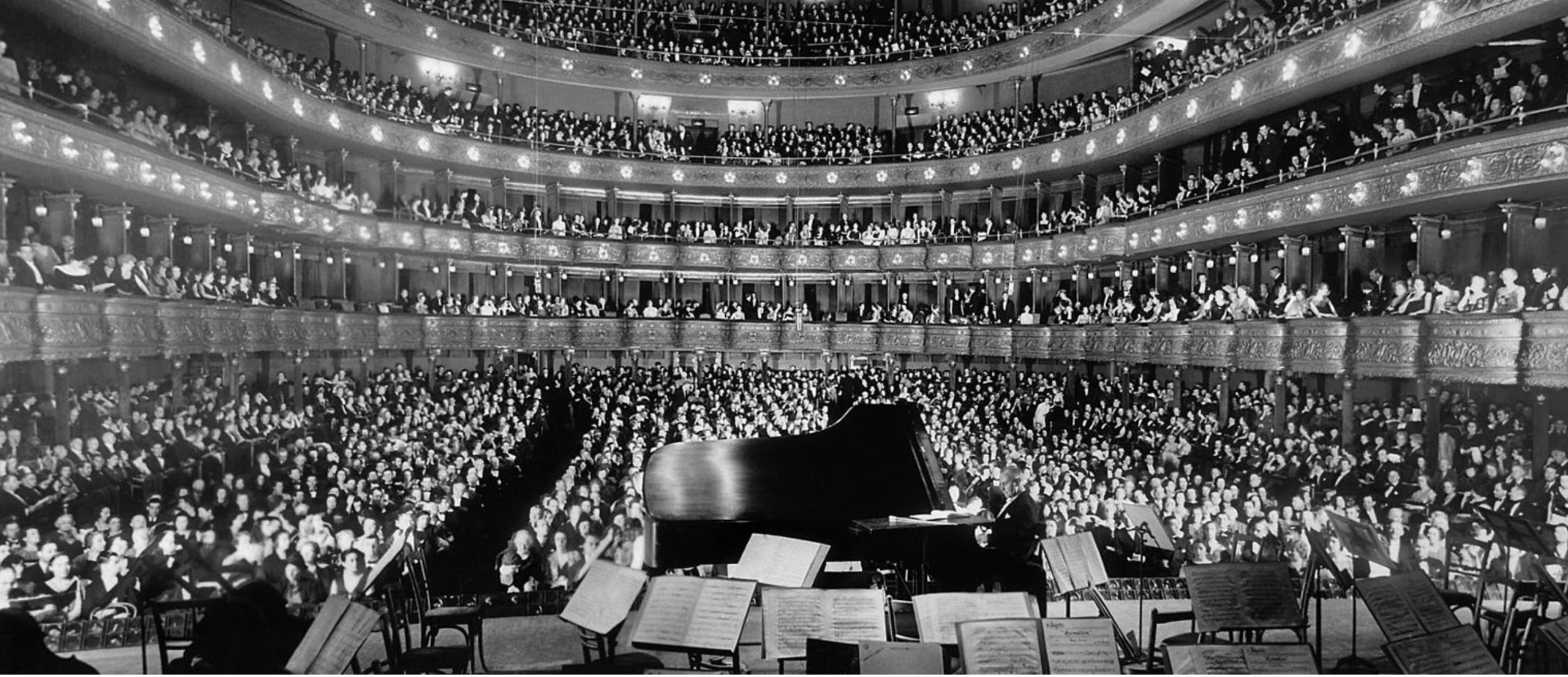 Black and white photograph of pianist playing at concert hall on Ronnie Stangler MD media and events page.