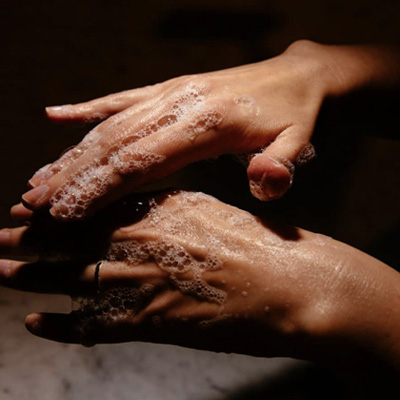 Color photograph of two hands being washed with soap on Ronnie Stangler mD media and events page regarding article by Dr. Stangler in The Ageist, COVID-19: Is "60" the New "70"?