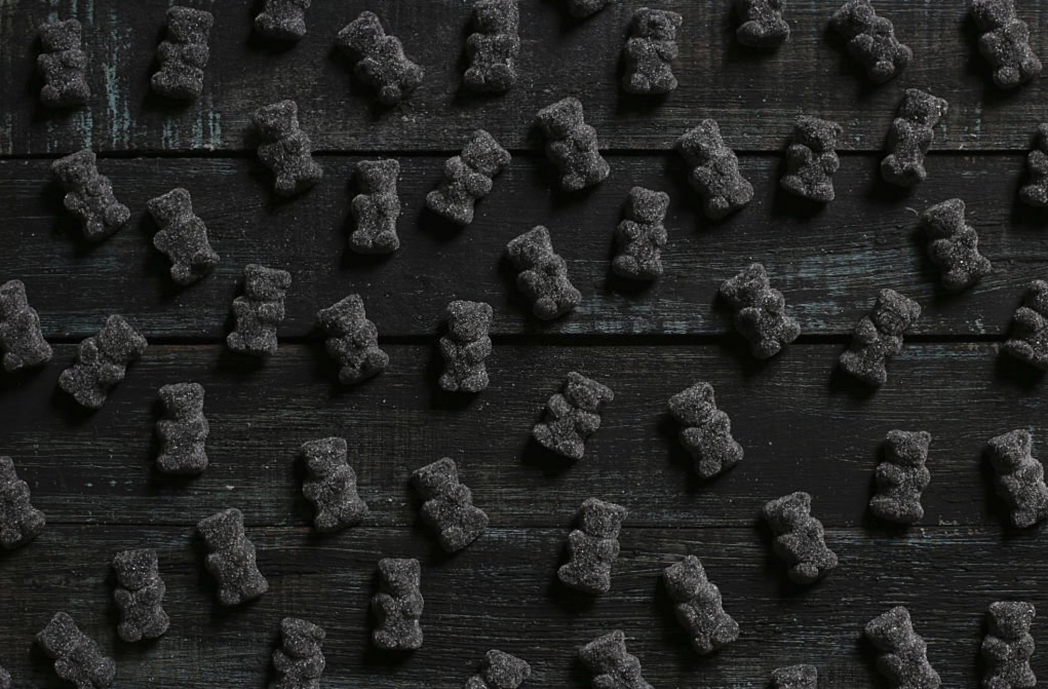 Black teddy bear gummy candies against black backdrop regarding melatonin supplement mislabeling for Ronnie Stangler MD good reads article on nutrition and epigenetics