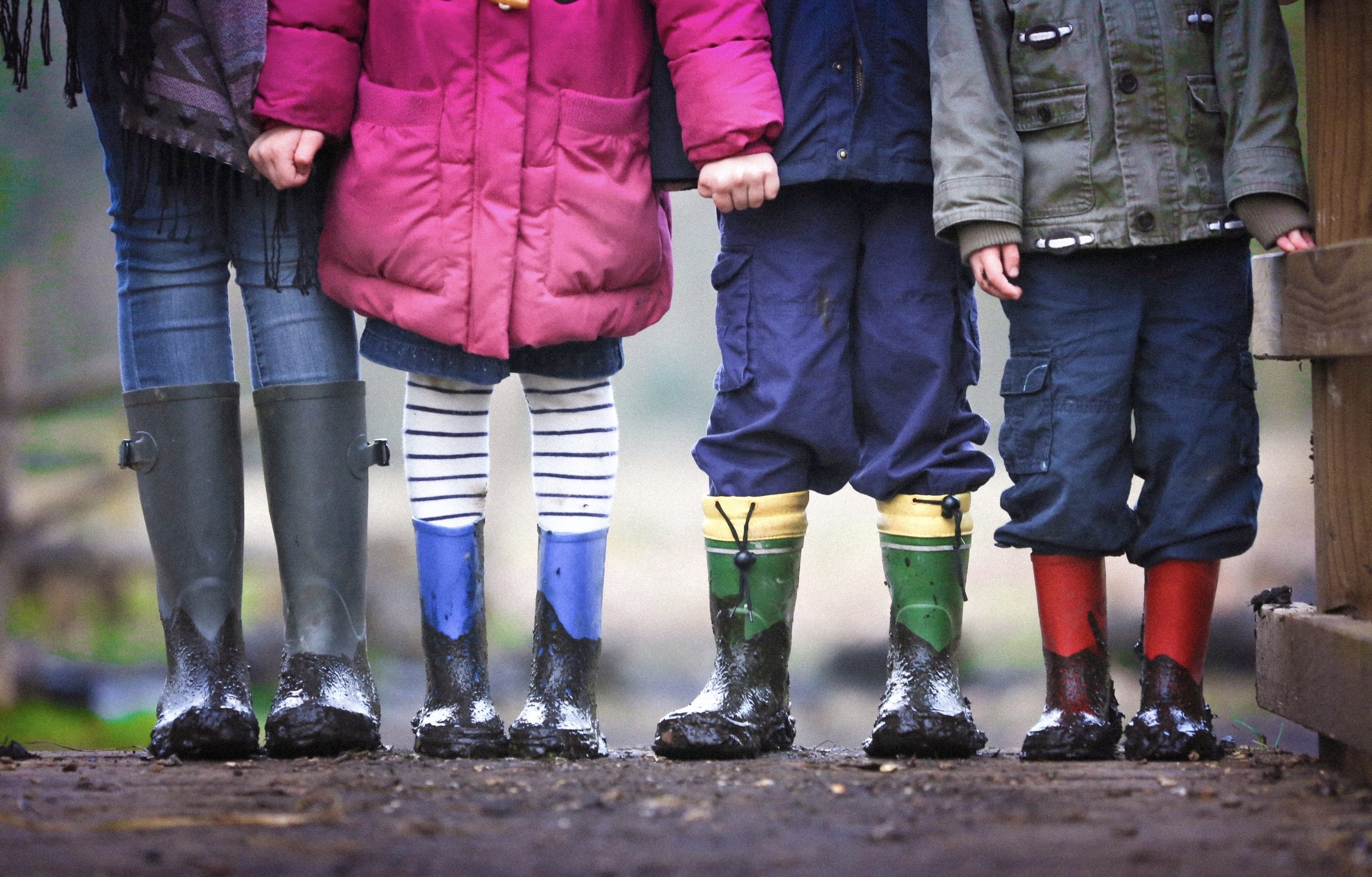 colorful photo of children from waist down wearing rubber boots